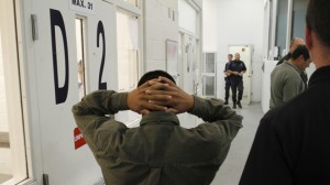 An undocumented immigrant is escorted at the Immigration and Customs Enforcement holding facility before being deported in Phoenix
